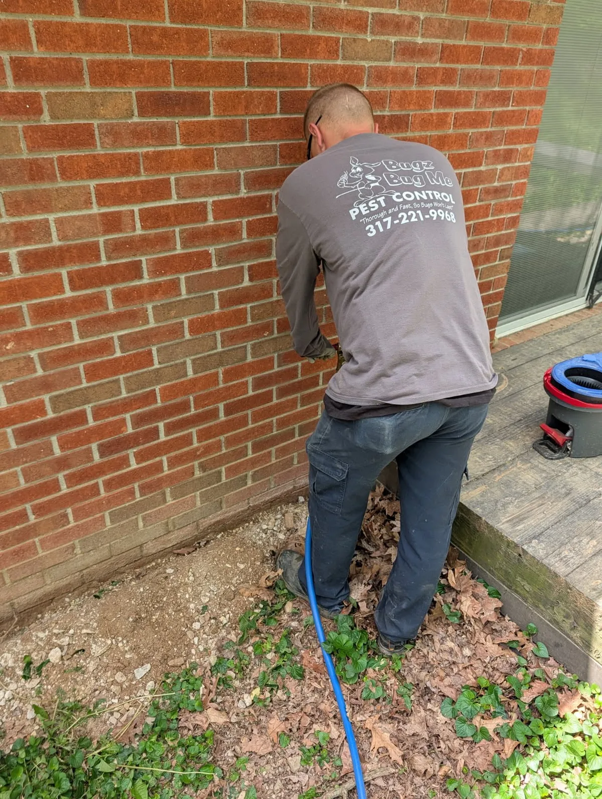 Bugz Bug Me technician precision drilling concrete slab for Termidor termite treatment in Indianapolis